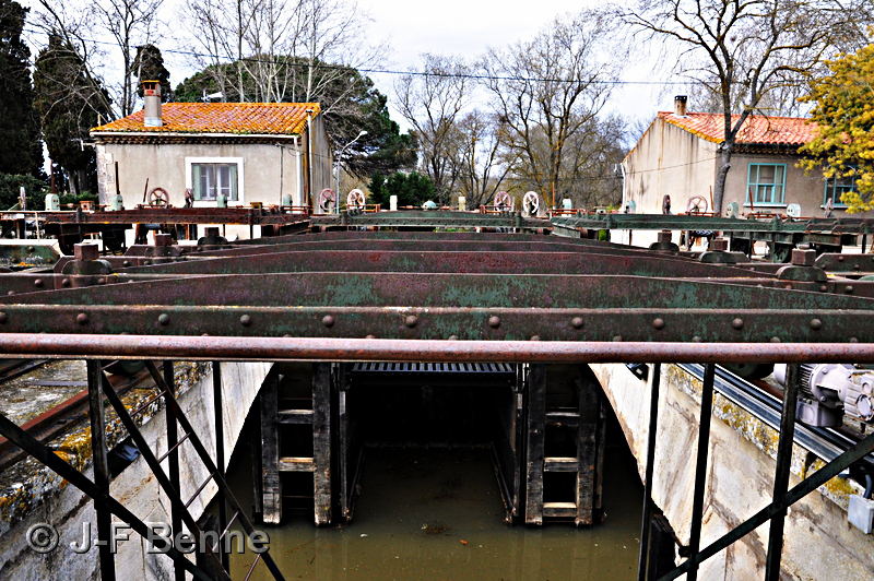 Vue du mécanisme suspendu sur rails qui permet aux bâches de coulisser pour la fermeture ou l'ouverture selon le cas, 
du Canal ou du Libron